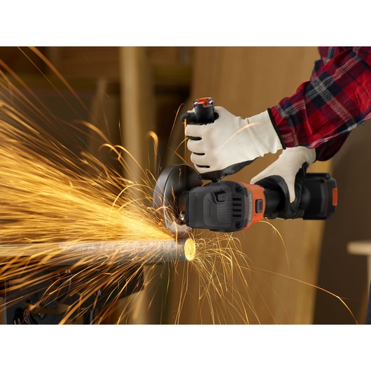 BLACKDECKER BCG6L8F1S cordless angle grinder in use cutting metal pipe, bright sparks flying, close-up action.