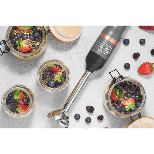 BLACK+DECKER BCKM1016KSG hand blender with stainless steel shaft on white surface beside jars of berries and seeds.