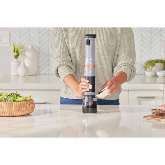 Photo of BLACKDECKER BCKM1012KG handheld cordless kitchen mixer being filled with ingredients in a modern kitchen.