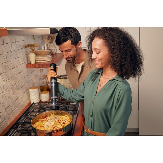 Photo of BLACK+DECKER BCKM101SPFF kitchen appliance in use over a stovetop pasta dish.