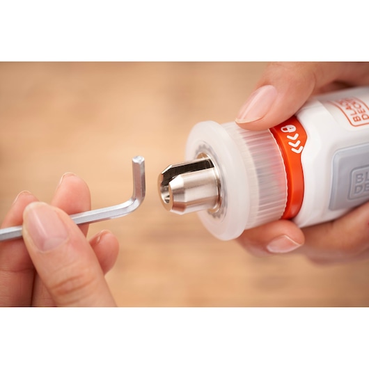 Close-up of BLACKDECKER BCRTA01 tool with hex key being inserted into metal chuck.