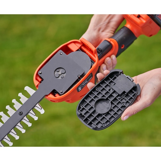 BLACKDECKER BCSS18D1 cordless shrub shear with open blade housing, close-up, outdoors.