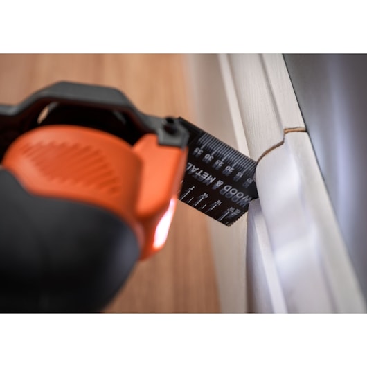 BLACKDECKER BDCOS18D1K oscillating tool cutting wood trim close-up.