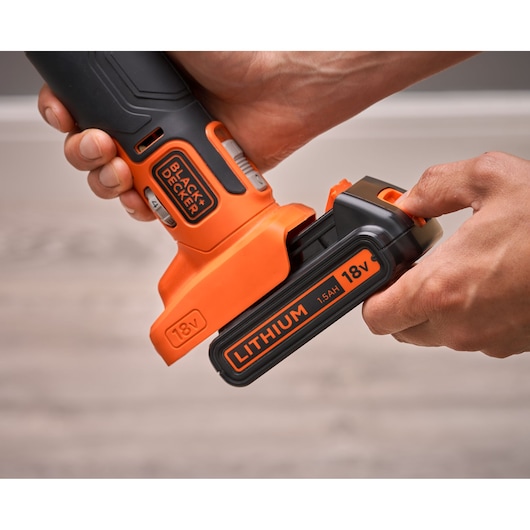 Photo of BLACKDECKER BDCOS18D1K cordless tool with 18V lithium battery being attached.