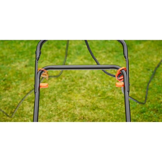 BLACKDECKER BEMW481BGL2 lawn mower handle frame with orange cable holders, outdoor grass background