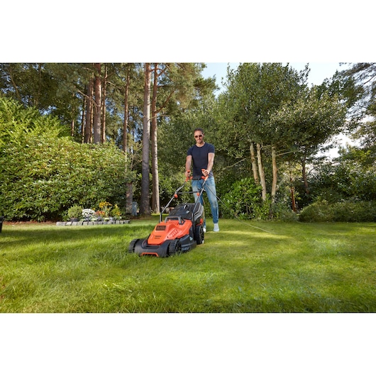 Photo of BLACKDECKER BEMW481BH lawn mower in use on green grass outdoors.