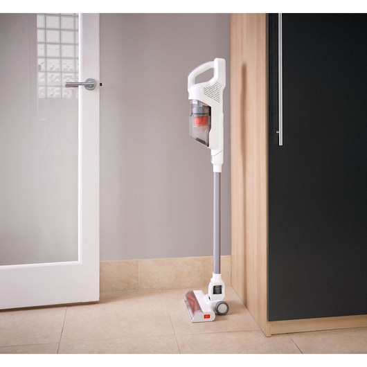 BLACKDECKER BHFEA515J cordless stick vacuum cleaner in white, upright in a kitchen corner
