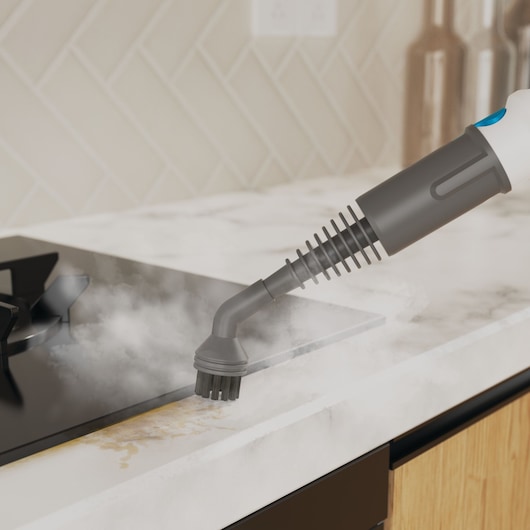 BLACKDECKER BHSMP2314 steam cleaner nozzle cleaning kitchen countertop near stove, close-up photo.