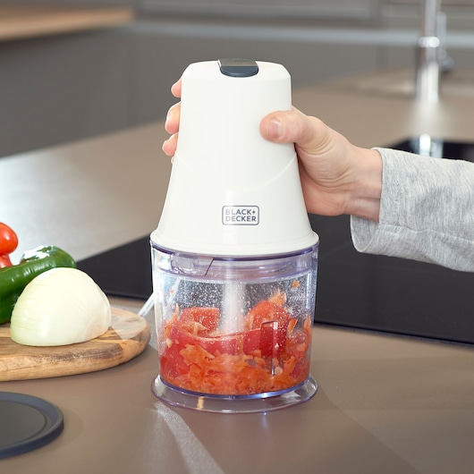 Photo of BLACKDECKER BXCH260E food chopper blending tomatoes on kitchen counter.
