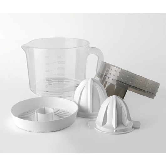 Assorted parts of a citrus juicer are shown, including a clear measuring jug, two white cone-shaped reamers, a white round base, and a grey strainer, all placed on a white surface.