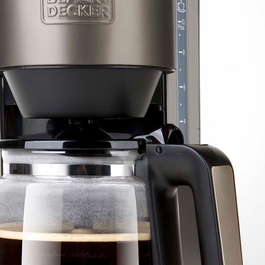 BLACK+DECKER BXCO1000E coffee maker close-up with glass carafe, black and stainless steel design, front angle.