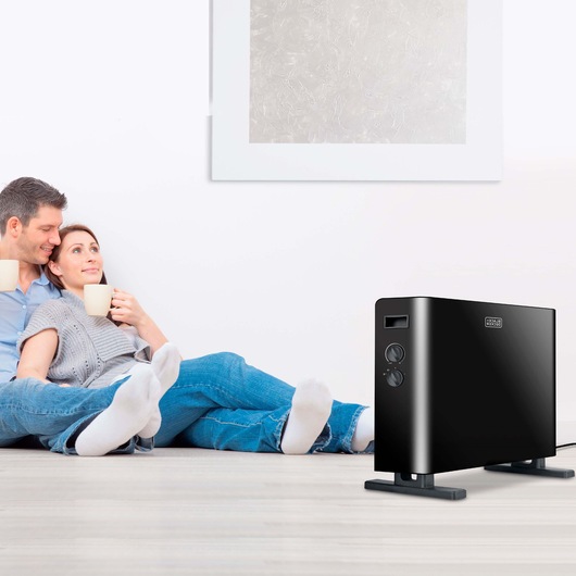 BLACKDECKER BXCSH2000E black convection heater displayed in a modern living room setting.