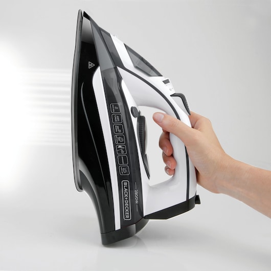 Photo of BLACK+DECKER BXIR2800E steam iron in black and white held in hand, left side view.