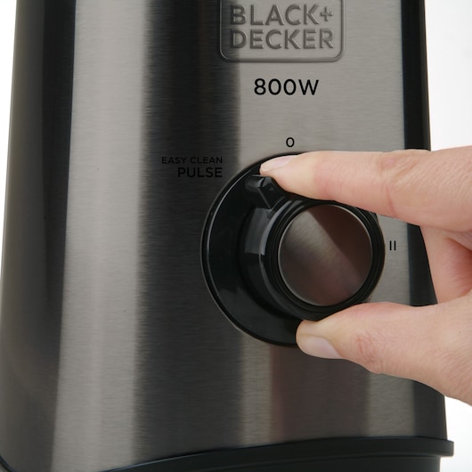 Photo of BLACK+DECKER BXJB800E blender control dial being turned, brushed metal finish, close-up view.