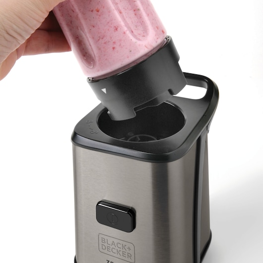BLACKDECKER BXJBA350E blender base with smoothie-filled blending cup being inserted, stainless steel finish.
