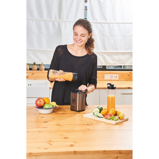 Photo of BLACKDECKER BXJBA350E blender on kitchen counter with fruits and smoothies.