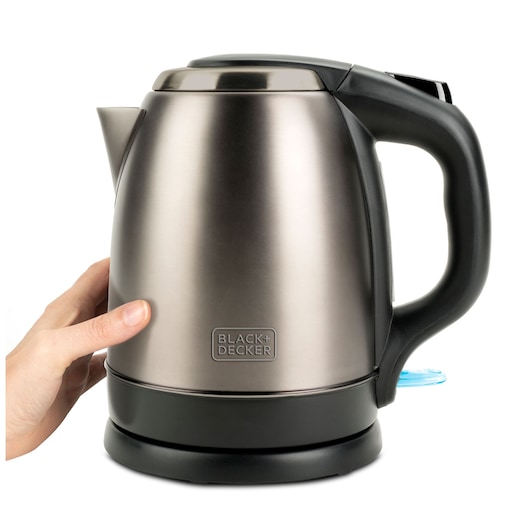 Photo of BLACK+DECKER BXKE2202E stainless steel electric kettle with black handle, side angle, a hand touching base.
