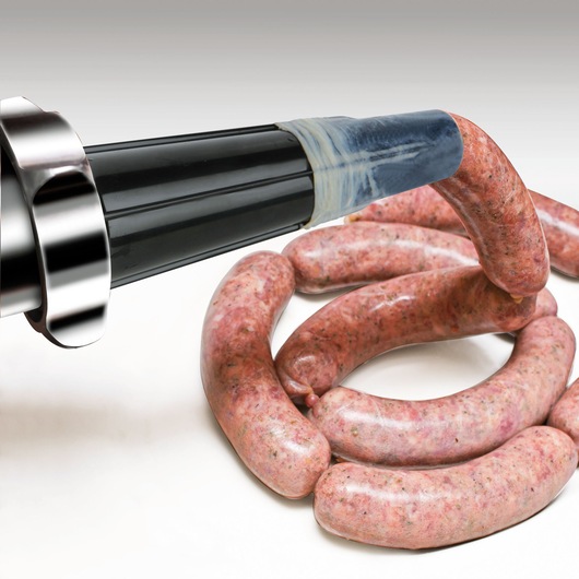 BLACKDECKER BXMM1000E meat grinder sausage attachment with raw sausages in preparation, close-up angle.
