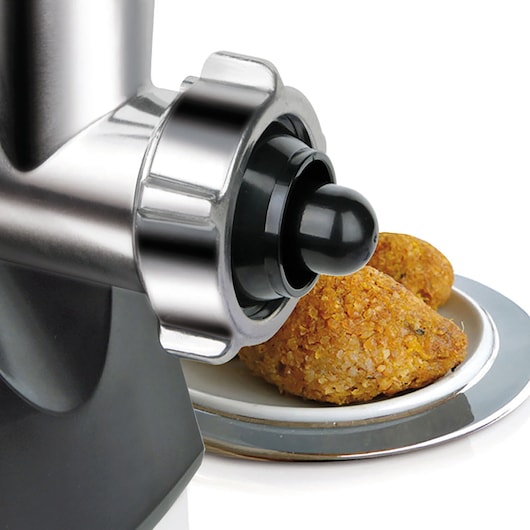 BLACKDECKER BXMM1000E meat grinder close-up with stainless steel body and falafel on a plate, side angle.