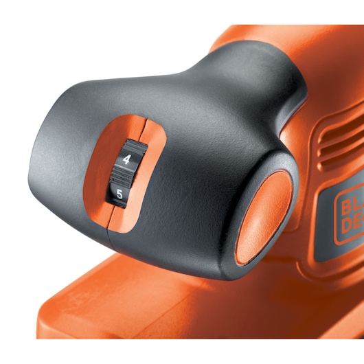 Close-up photo of BLACKDECKER KA320E sander speed control dial, black and orange housing, white background.